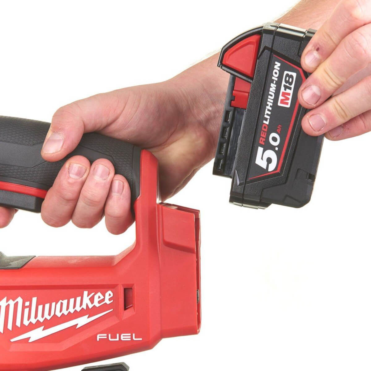 Hand holding a Milwaukee Jigsaw and battery  on a white background
