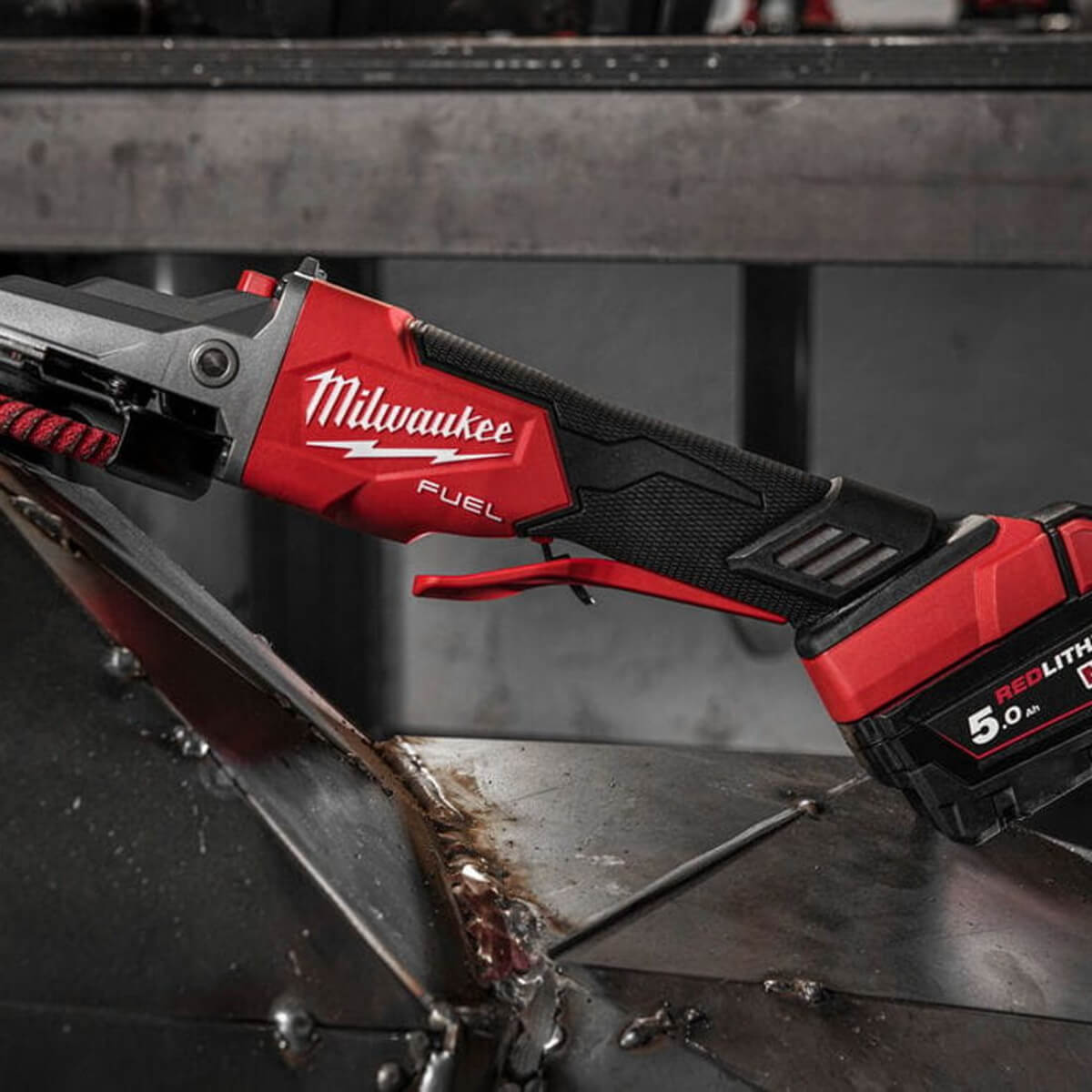 Milwaukee power tool on a metal surface with a blurred background