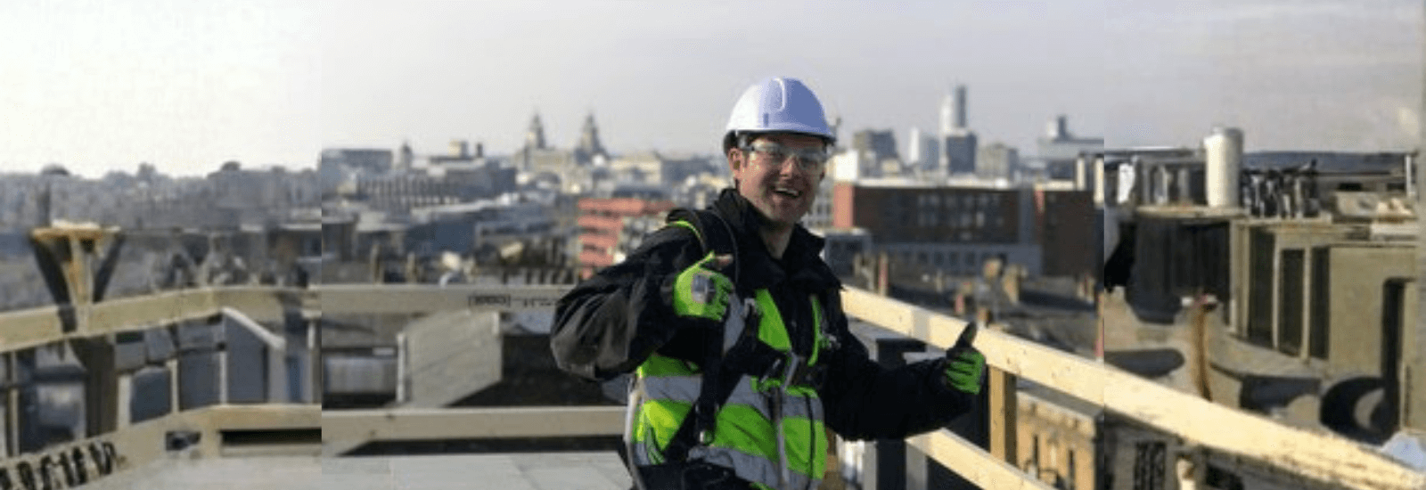 That's me  in safety gear on a rooftop with a cityscape in the background